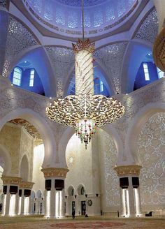 the inside of a large building with chandeliers and lights hanging from it's ceiling