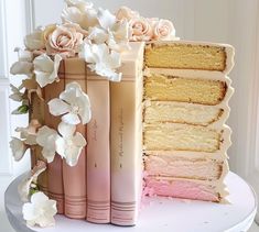 there is a cake with layers and flowers on it