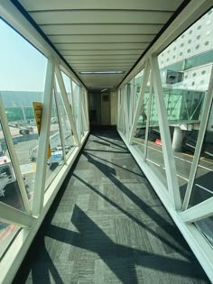 an empty hallway leading to the top floor of a building with lots of windows on both sides