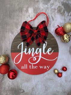 a christmas ornament that says, jingle all the way with ornaments around it