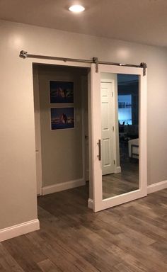 an empty living room with sliding glass doors and wood flooring in the middle of it