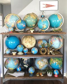 an assortment of globes on shelves in a room