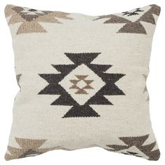 a white and brown pillow with an arrow design on the front, sitting against a white background