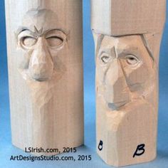 two wooden sculptures with faces on them, one in the shape of a man's head