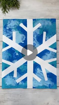 a snowflake is shown on a piece of paper with the video below it