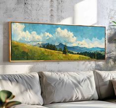 a painting hanging on the wall above a couch in a room with a white sofa