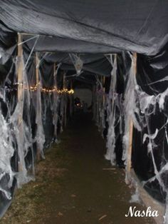 the inside of a tent covered in black and white fabric with icing on it