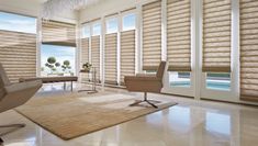 a living room filled with furniture and windows covered in blinds