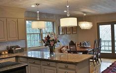 a large kitchen with an island in the middle and lots of counter space on one side