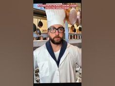 a man wearing a chef's hat and glasses standing in front of some cooking utensils