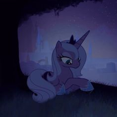 a pony sitting in the grass near a tree at night with its head turned to the side