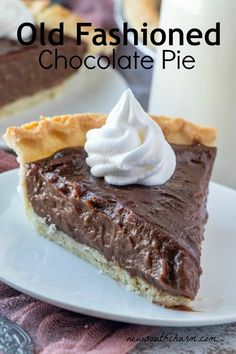 an old fashioned chocolate pie on a white plate with whipped cream and a glass of milk in the background