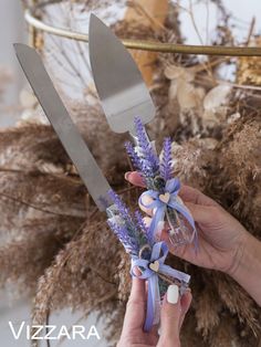 a person holding scissors and flowers in front of some dried plants with the words vizzara on it