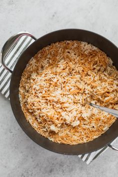 a pan filled with rice on top of a table