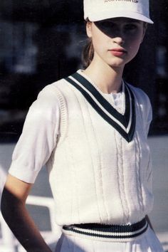 a woman wearing a white hat and dress