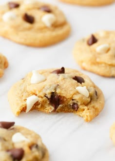 cookies with chocolate chips and marshmallows are on a baking sheet