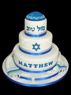 a three tiered cake decorated with blue and white stripes