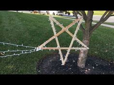 a wooden star is attached to a tree