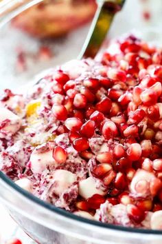 pomegranates are mixed together in a glass bowl