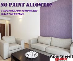 a living room with two couches and a coffee table in front of a purple wall