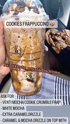 a person holding up a cup with cookies in it and the words cookies frapuccino