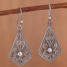 These exquisite dangle earrings showcase the delicate and intricate beauty of filigree. Peruvian artisan Alfredo Inga handcrafts these sterling silver earrings in a kite shape with a rope motif border and filigree scrolls connecting to a bead at the center. The earrings are oxidized to give them an antiqued look. Filigree Jewelry, Mens Silver Necklace, David Yurman Jewelry, Knot Earrings, Sterling Silver Filigree, Antique Earrings, Silver Filigree, Oxidized Sterling Silver, Copper Earrings