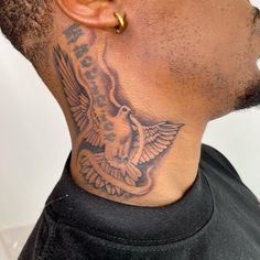 a man with a bird tattoo on his neck and behind his ear is an ear piercing