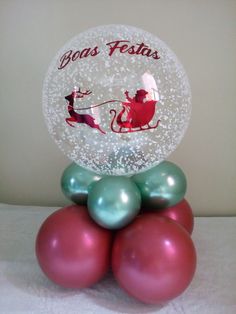 a glass ornament with santa riding a sleigh on top of christmas balls