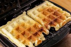 two waffles sitting on top of a black pan