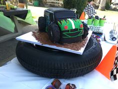 there is a cake made to look like a tractor on top of a large tire