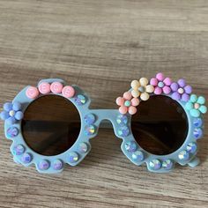 Personalized kids flower sunnies for some springtime cheer. These make the cutest Spring accessory or basket stuffer. Sunnies fit children around age 2-10. TO ORDER:There are a few ways to customize the sunglass style, beads, and colors: Select Bead Design: There is a wide selection of beads to choose from. Reference picture for options. Add Sparkle: Option to add pearls or rhinestones around the lenses, or no sparkle. Reference picture for options. Select Name Bead Color: Choose between white o Playful Multicolor Sunglasses For Spring, Fun Multicolor Sunglasses For Spring, Fun Multicolor Spring Sunglasses, Cute Customizable Sunglasses For Beach, Cute Summer Sunglasses For Birthday, Fun Pink Handmade Sunglasses, Cute Flower Shaped Sunglasses With Uv Protection, Handmade Fun Pink Sunglasses, Fun Handmade Pink Sunglasses