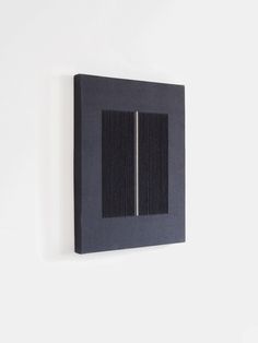 a black square shaped object mounted on the wall