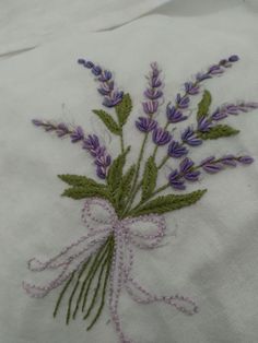 a close up of a piece of cloth with flowers embroidered on the front and back