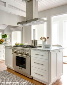 a stove top oven sitting inside of a kitchen next to an oven and countertop