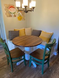 a kitchen table with four chairs and a bench in front of the counter top is made out of wood