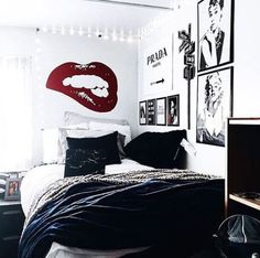 a bed room with a neatly made bed and pictures on the wall