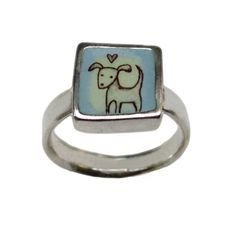 a ring with an image of a sheep and heart on the front, in silver