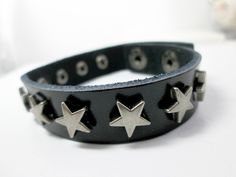 "Beautiful and trendy punk rock star bracelet with spikes rivet stars, great for men, women, boys or girls.  It features an adjustable flat leather bracelet with star charms on it and snap button clasp closure.  This bracelet is suitable for everyday wear.  Ideal birthday gift, perfect gift. Measurement: Bracelet approx. 7\" - 8\" in length (fits 6.5\" - 7.5\" wrist) wrist band approx.: 1/2\" in width   Material:   leather To view my other gift ideas, please visit my shop: https://www.etsy.com/shop/TrendHub Thank you for stopping by and happy shopping" Black Rocker Style Leather Bracelet With Studs, Rocker Leather Bracelet With Studs, Adjustable Studded Leather Rocker Bracelet, Edgy Adjustable Star-shaped Jewelry, Black Leather Bracelet With Studs For Rock Style, Adjustable Edgy Star Jewelry, Black Studded Leather Bracelet In Rock Style, Adjustable Edgy Star-shaped Jewelry, Adjustable Star-shaped Edgy Jewelry