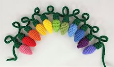 crocheted christmas lights are arranged in the shape of a wreath on a white background