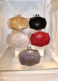 "These are high-end evening purses made with genuine Swarovksi Crystals imported from Austria. They are not common rhinestones. Swarovski Crystals have unmatched sparkle and brilliance. They shine like diamonds! Each bag comes with a Certificate of Authenticity and is shipped from the U.S.A. Heart- stoppingly beautiful! These Formal Evening Purses in ALL SIAM RED, ALL SILVER GRAY, ALL LT. TOPAZ GOLD. All JET BLACK and ALL CLEAR AURORA BOREALIS Crystals in a hexagon shape will be the talk of town Luxury Rhinestone Evening Bag For Gala, Luxury Evening Bag With Rhinestones For Gala, Glamorous Crystal Embellished Evening Bag For Galas, Glamorous Crystal Embellished Evening Bag For Gala, Luxury Sparkling Evening Bag For Events, Luxury Bedazzled Evening Bag For Party, Luxury Sparkling Evening Bag For Formal Occasions, Luxury Sparkling Evening Bag For Formal Events, Luxury Sparkling Evening Bag For Wedding