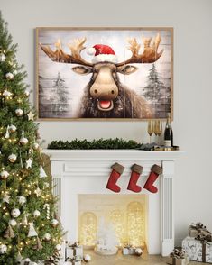 a decorated christmas tree in front of a fireplace with a moose painting on the mantle