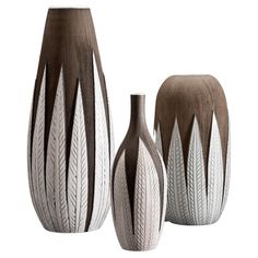 three vases with different designs on them sitting next to each other in front of a white background