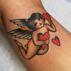 a tattoo with an angel holding a heart on it's arm, and two hearts in the other hand