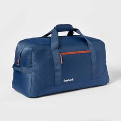 a blue duffel bag with an orange zipper on the front and side pocket,