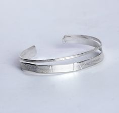 Silver Bracelet - Roller-printed and hammered texture brings unique, wave-like patterns to this split sterling silver cuff bracelet. Each is unique and will vary slightly.<br><br><b>Dimensions: </b><br>Small: 5.5L<br>Medium: 6L<br>Large: 6.5L Silver Bangle Bracelets Unique, Soldering Jewelry, Artful Home, Sterling Silver Cuff Bracelet, Silver Bangle Bracelets, Sterling Silver Bangles, Sterling Silver Cuff, Silver Cuff Bracelet, Jewelry Inspo