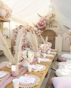 the table is set with pink and white decorations