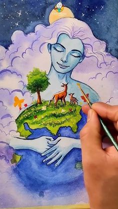 a person is holding a paintbrush and drawing an image on paper with watercolors