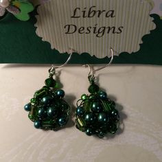 the earrings are green and have pearls on them