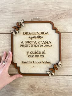 a wooden plaque with spanish words on it