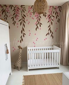 a baby's room decorated in pink and brown